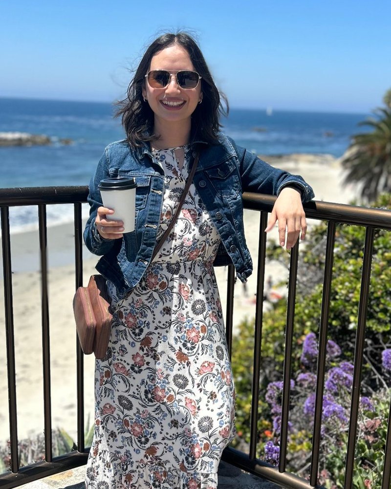 Karen Calderon, financial coach, smiling by the ocean